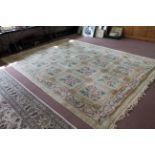 A Chinese wool carpet pale ground with twenty square floral panels,