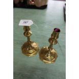 A pair of 18th Century brass candlesticks with knopped stems and petal shaped bases,