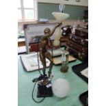 An Art Deco style lamp as a dancing girl holding an alabaster lamp and frosted glass shade