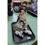 Four Staffordshire figurines including flat back of man with gun and dog,