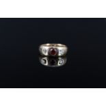 A gents 18ct gold diamond and garnet three stone ring, size N 1/2, approx 6.