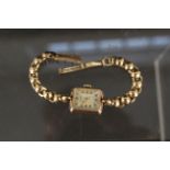 A 9ct gold lady's Benson wristwatch on 9ct gold strap