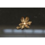 A 9ct gold floral brooch set with single pearl,