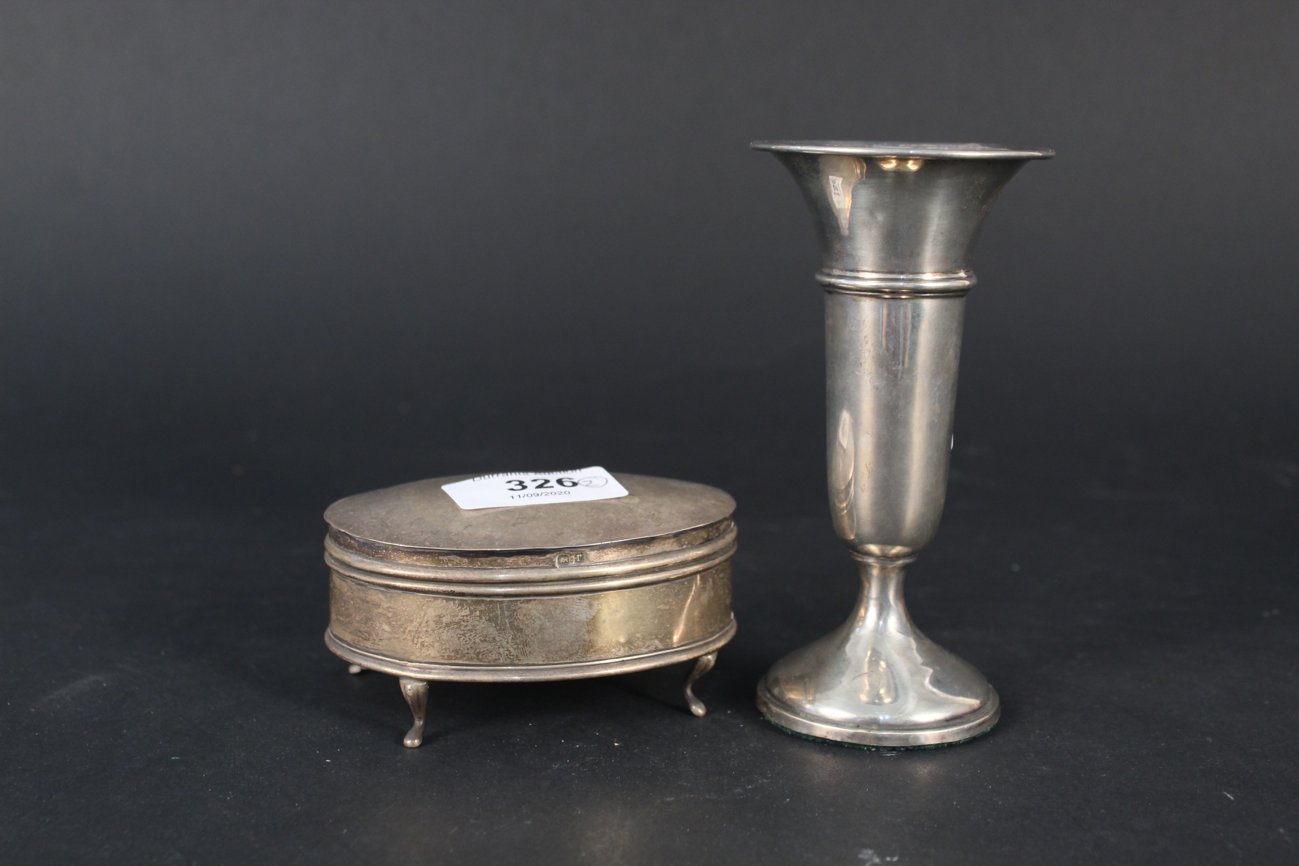 An oval silver ring box (interior as found) together with a silver bud vase