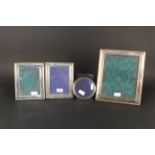 A large silver photograph frame with ribbed edge detail,