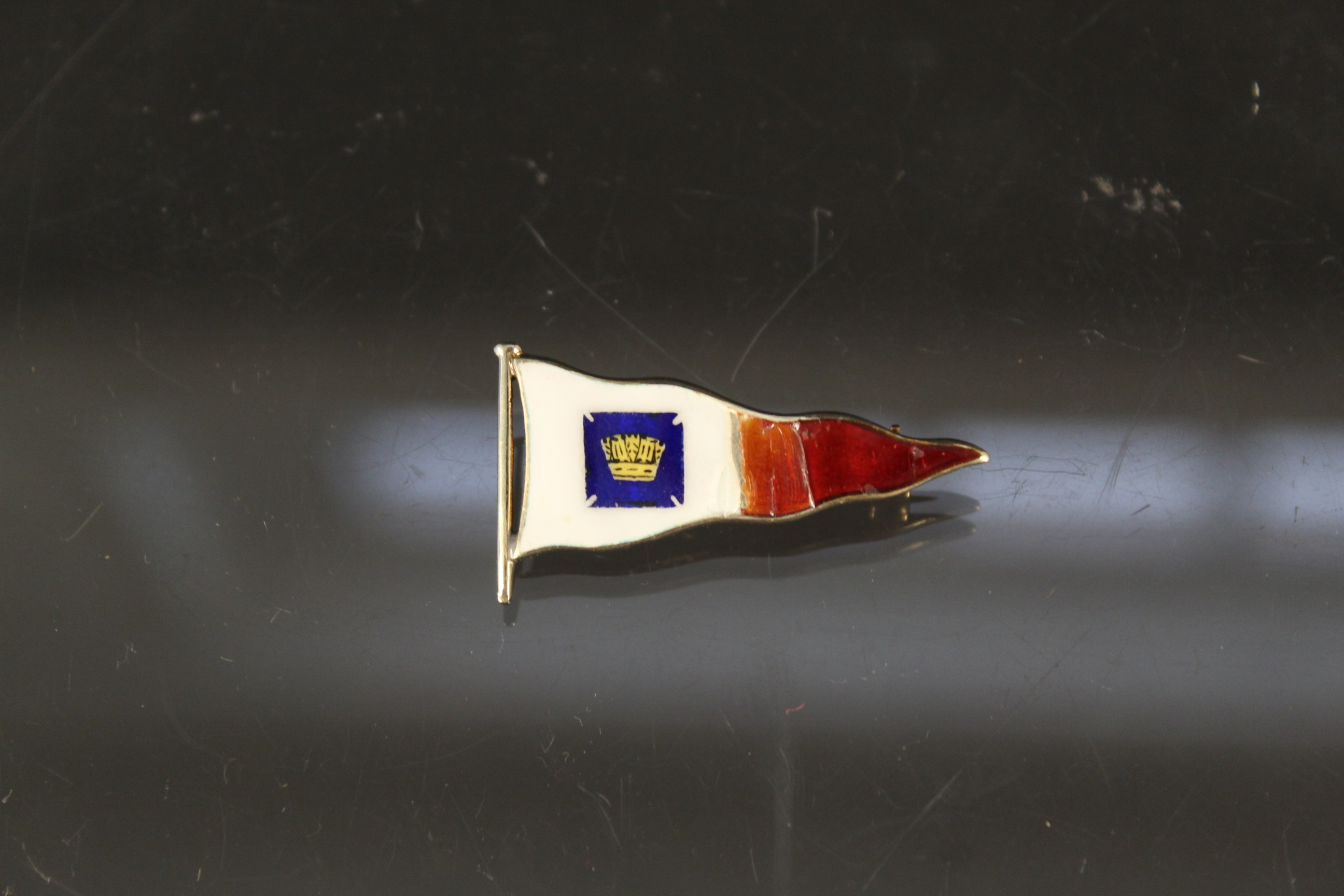 A 9ct gold enamelled flag brooch (as found),