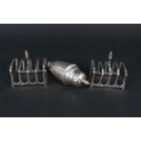 A pair of silver toast racks (as found) together with a silver sifter (as found),