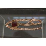 A 9ct rose gold watch chain with clip and T-bar plus a 9ct gold stone set swivel fob,