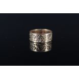 An unmarked yellow metal band ring with engraved floral decoration (worn), size P, approx 3.