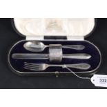 A boxed silver christening set including spoon, fork, knife and napkin ring,