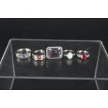 Five silver stone set rings including opal, tanzanite, quartz, ruby and sapphire,