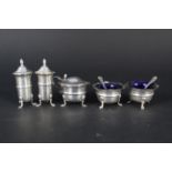 A four piece silver condiment set with two matching spoons, Birmingham 1938,