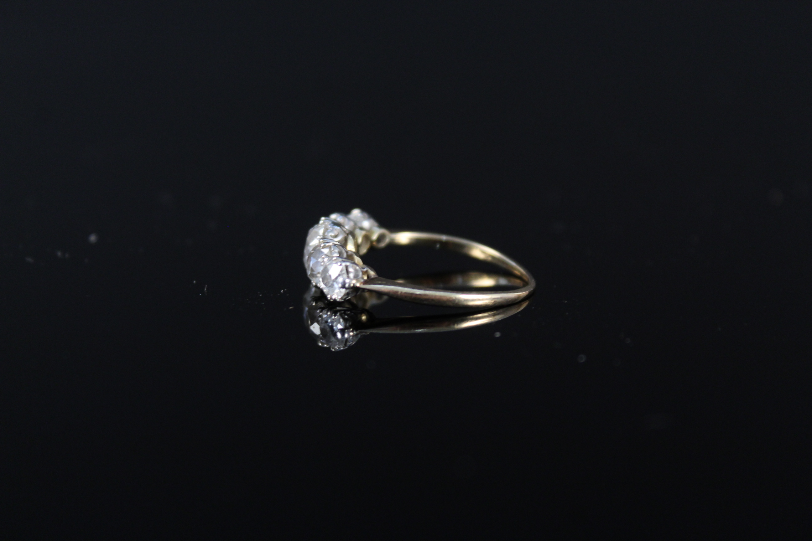 An impressive five stone diamond ring, the graduating old cut diamonds claw mounted in white metal, - Image 3 of 3