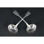 A pair of Georgian silver ladles with crested handles,