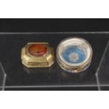 A glass pill box with painted floral decoration,