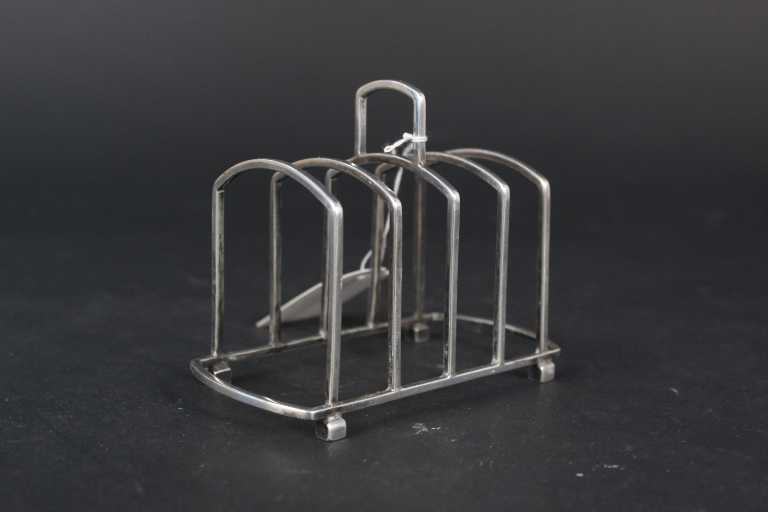 A silver four slice toast rack, Birmingham 1922 by Martin Hall & Co Ltd,