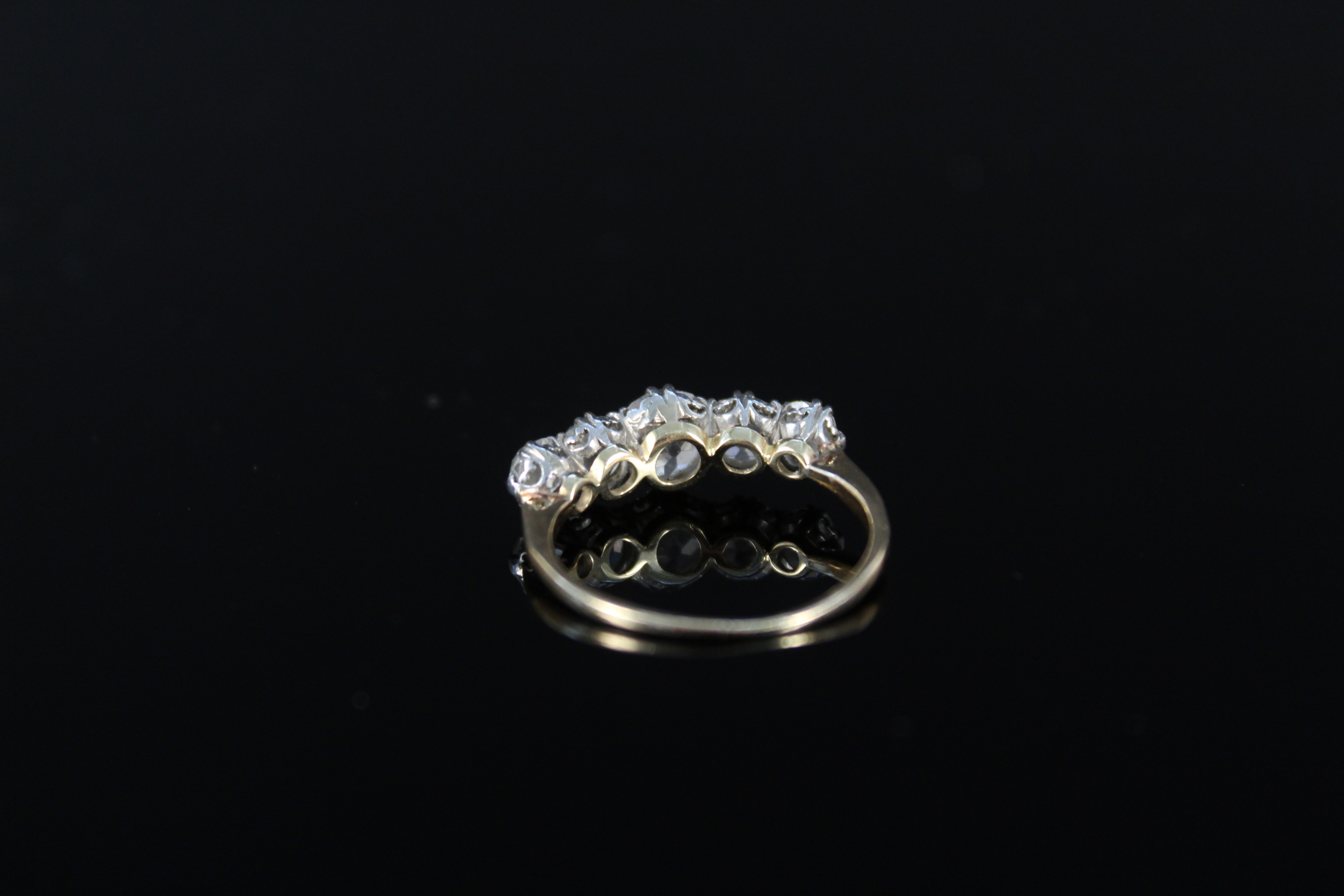 An impressive five stone diamond ring, the graduating old cut diamonds claw mounted in white metal, - Image 2 of 3