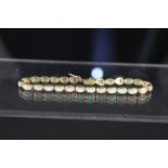 An 18ct gold opal set bracelet consisting of twenty seven oval collet set opals,