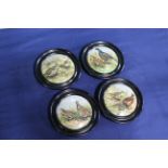 A set of four framed antique 'pot lids' depicting game birds