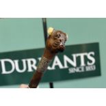 A Victorian walking stick with carved dogs head top with spring loaded jaw,