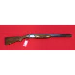 A Browning over and under 12 bore shotgun with 26" barrels and 2 3/4" chambers,