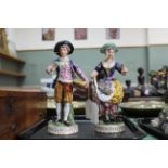 A pair of early 19th Century possibly Derby porcelain figures of a flower girl and a baker boy,