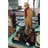 A tray with a large German wood carving of a man, Chinese wood carvings, two metal male figures,