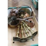 A small brass preserving pan and saucepan, two pairs of brass candlesticks,