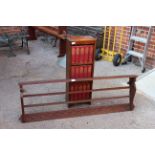 A carved oak hanging plate rack and oak bookcase with encyclopedias