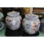 A pair of 19th Century hand painted in Imari colours, Chinese lidded ginger jars,