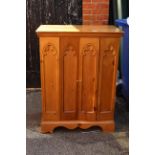 A pine Gothic style bi-fold TV cupboard