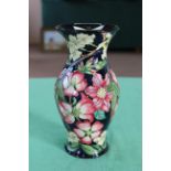 A Moorcroft scarce vase decorated with clematis and jasmine flowers with bee on the lip,