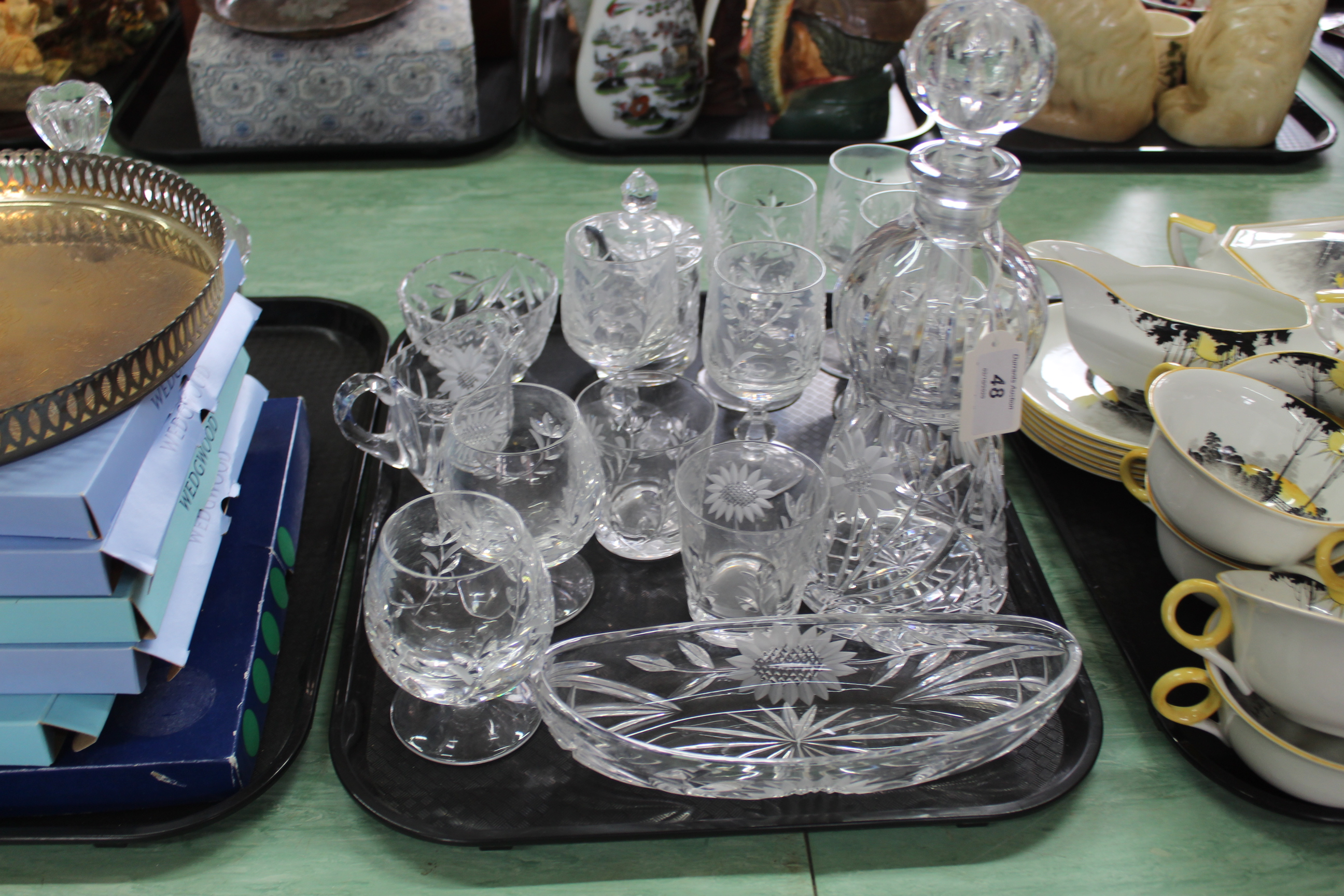 A set of sunflower design glassware including six sherry glasses, decanter,