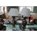 A pair of metal based Chinese style table lamps decorated with raised birds,