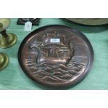 An Arts and Crafts Newlyn copper charger with repousse and chased decoration of a galleon in full