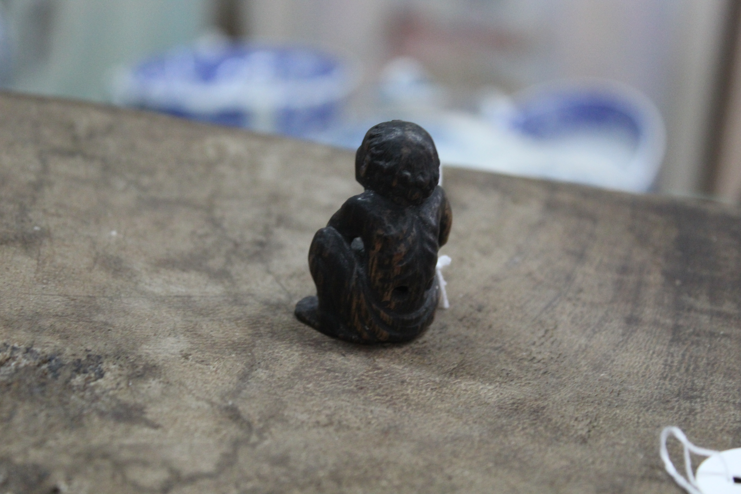 An antique carved wood netsuke on an emaciated man with pot, inset metal eyes, not signed, - Image 2 of 3