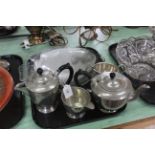 A hand beaten pewter four piece tea set plus a set of glass fish plates with serving dish