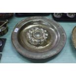 A 16th/17th Century Nuremberg brass alms dish with raised gadrooned central boss and circles of