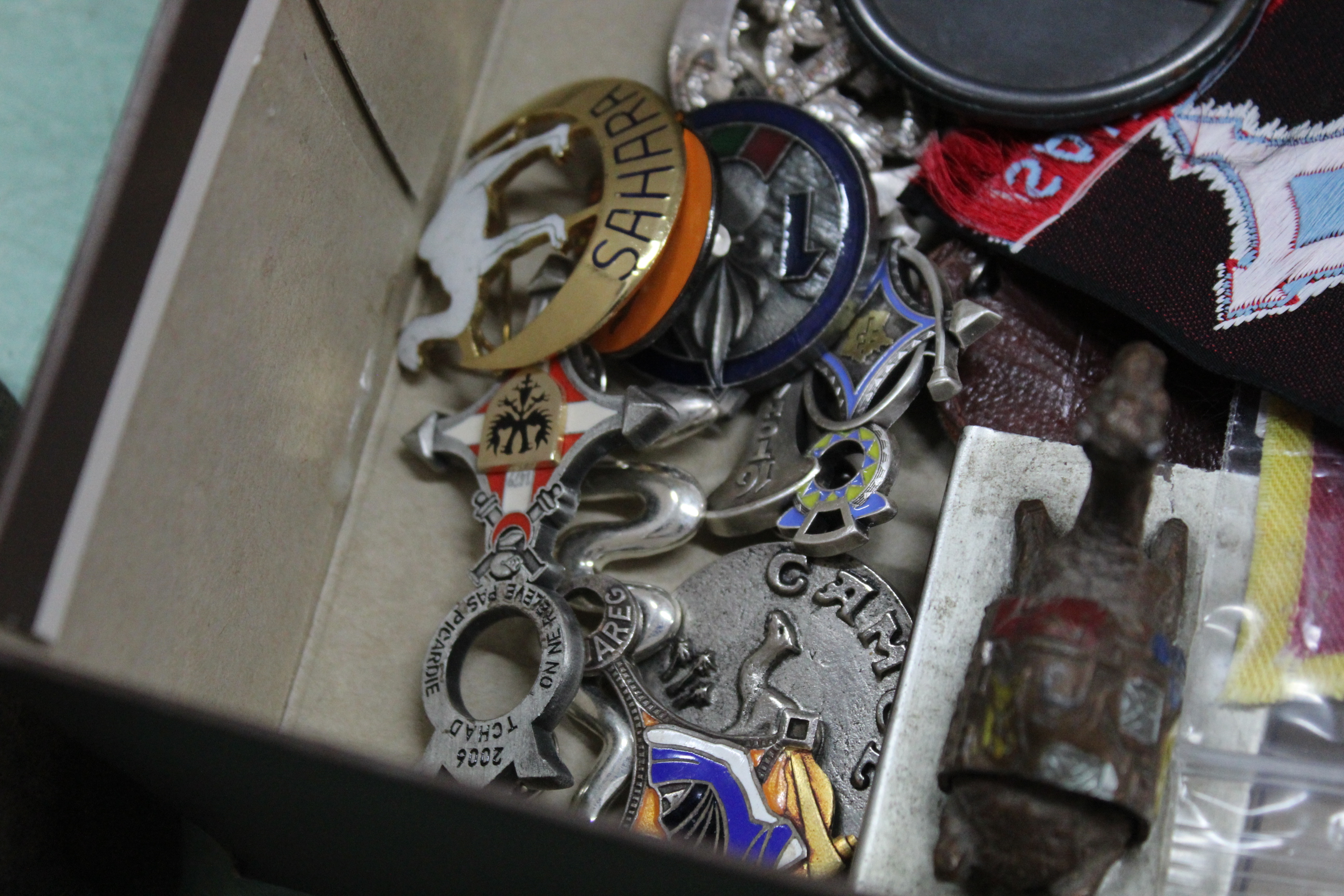 A painted spelter figure of a camel matchbox holder together with a selection of badges and patches - Image 2 of 3