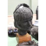 A sculptured metal head of a woman, unsigned,