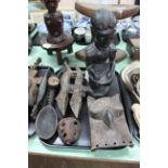 A tray with seven antique carved wood figures including an ebony seated figure, an owl,