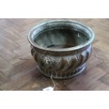 An 18th Century circular copper jardiniere or wine cooler with gadrooned and punched decoration and