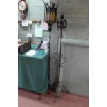Two wrought iron tripod candle stands,