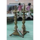 A pair of 17th/18th Century continental brass pricket candlesticks with circular drip trays,