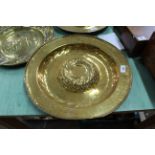 A 16th/17th Century Nuremberg brass alms dish with raised gadrooned central boss and three circles