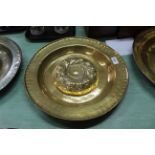 A 16th/17th Century Nuremberg brass alms dish with raised gadrooned central boss within a circle of