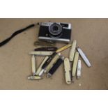 A collection of sixteen vintage penknives plus an Olympus Trip 35mm camera