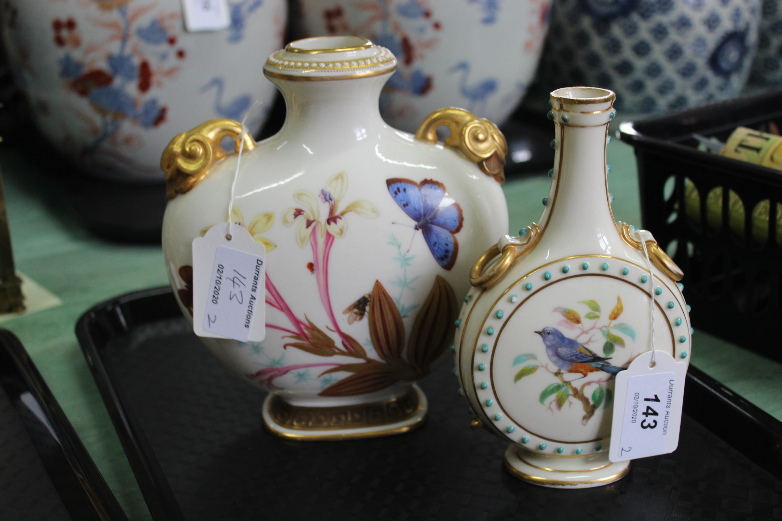 Two Worcester flask vases, one with bird portraits, the other with butterflies and flowers,