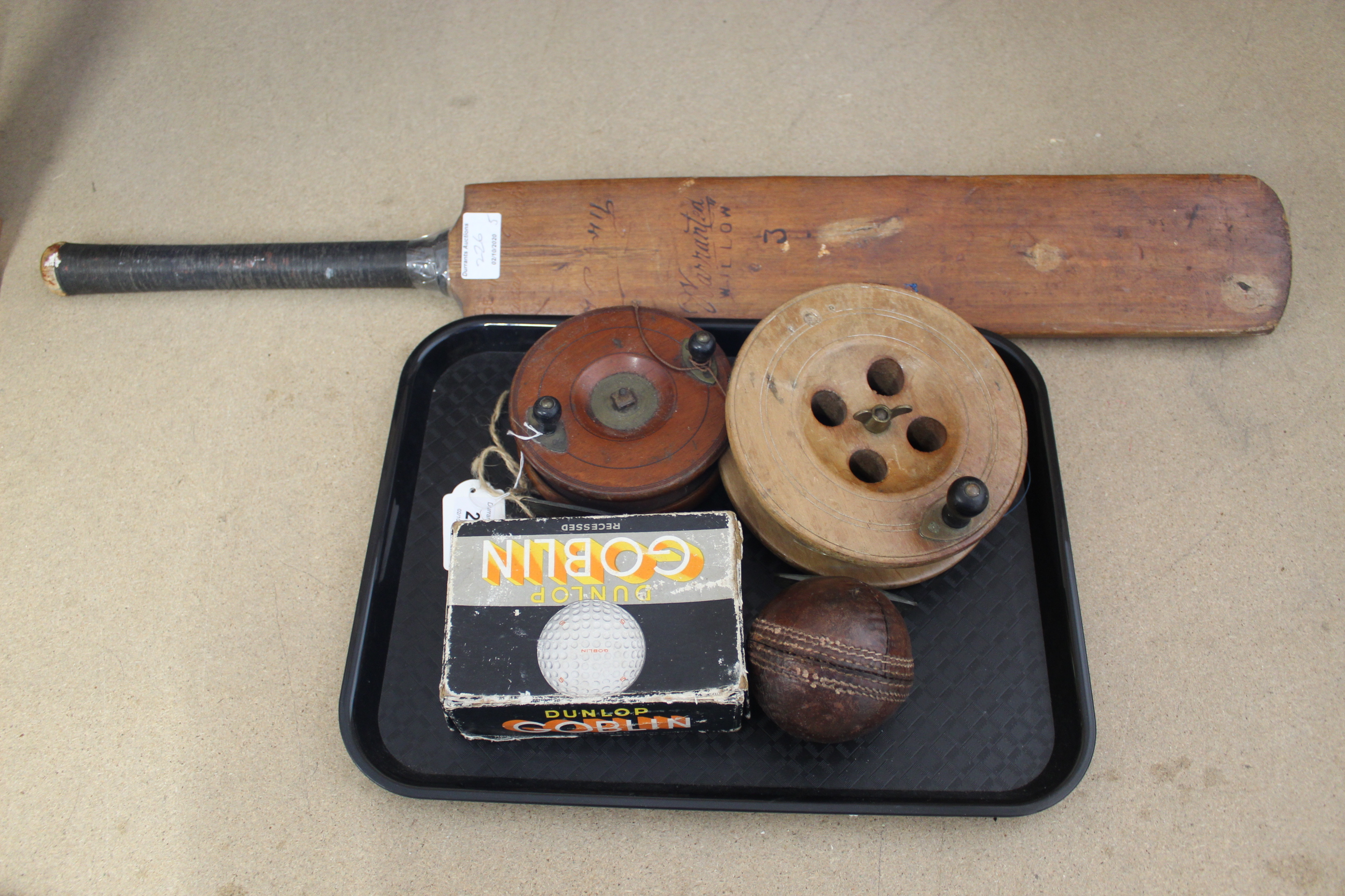 Two vintage wooden sea reels, a vintage cricket ball,