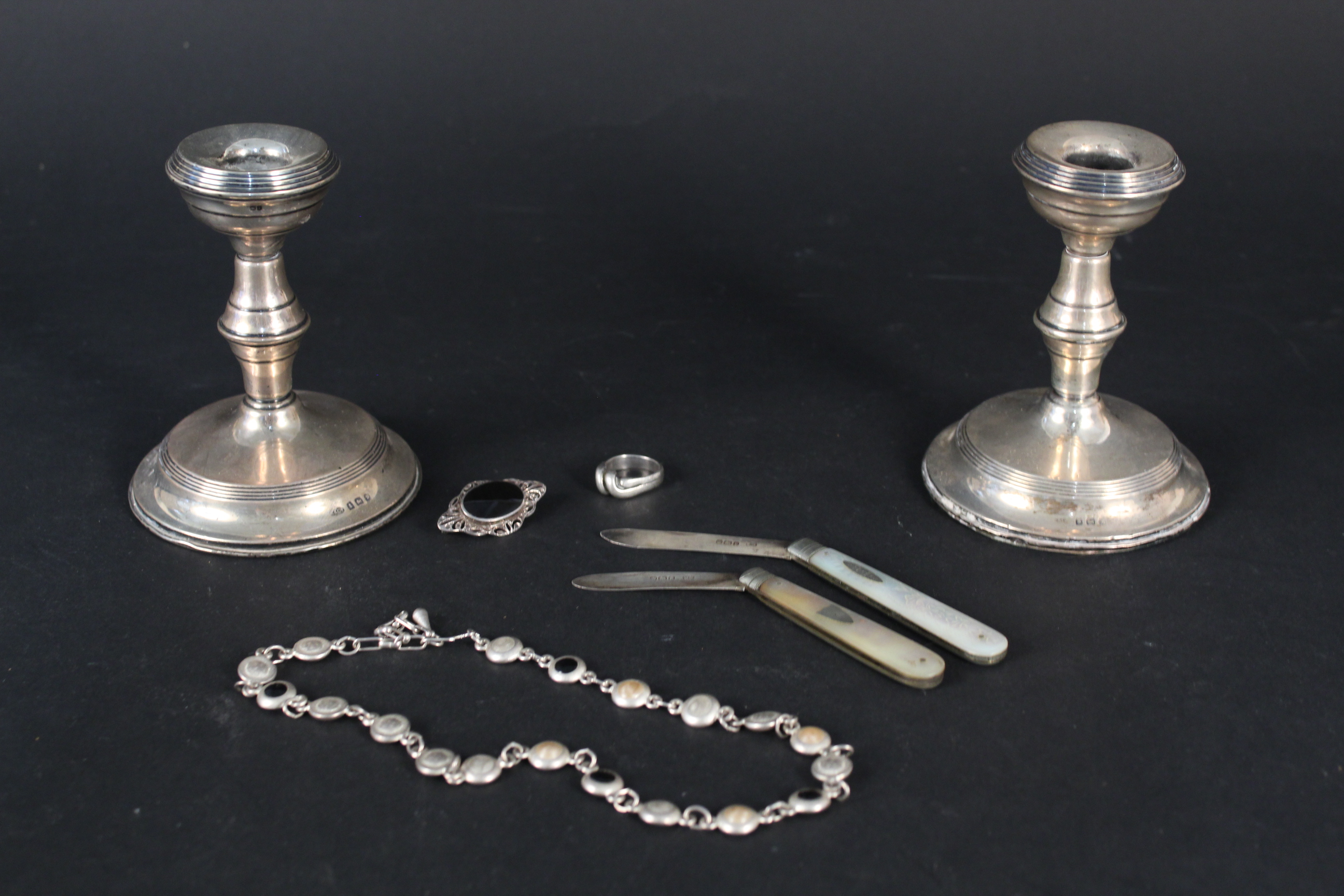 Two silver bladed mother of pearl pen knives, a pair of squat candlesticks,